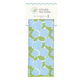 A packaged kitchen tea towel with a light blue and green hydrangea pattern, shown on a white background with a branded header card. Available at Be Charmed