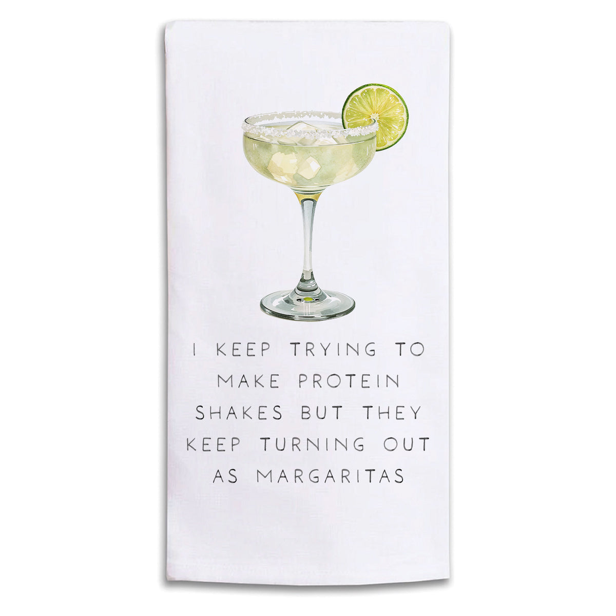 A Rustic Marlin white kitchen towel featuring a printed illustration of a margarita with a lime slice and the humorous text, 'I KEEP TRYING TO MAKE PROTEIN SHAKES BUT THEY KEEP TURNING OUT AS MARGARITAS'. Available at Be Charmed
