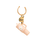 A blush colored tumbler keychain with a flower detail on a white background, attached to a keyring. Available at Be Charmed