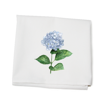 A white kitchen towel with a printed hydrangea flower design and green leaves on it, made of cotton. Available at Be Charmed