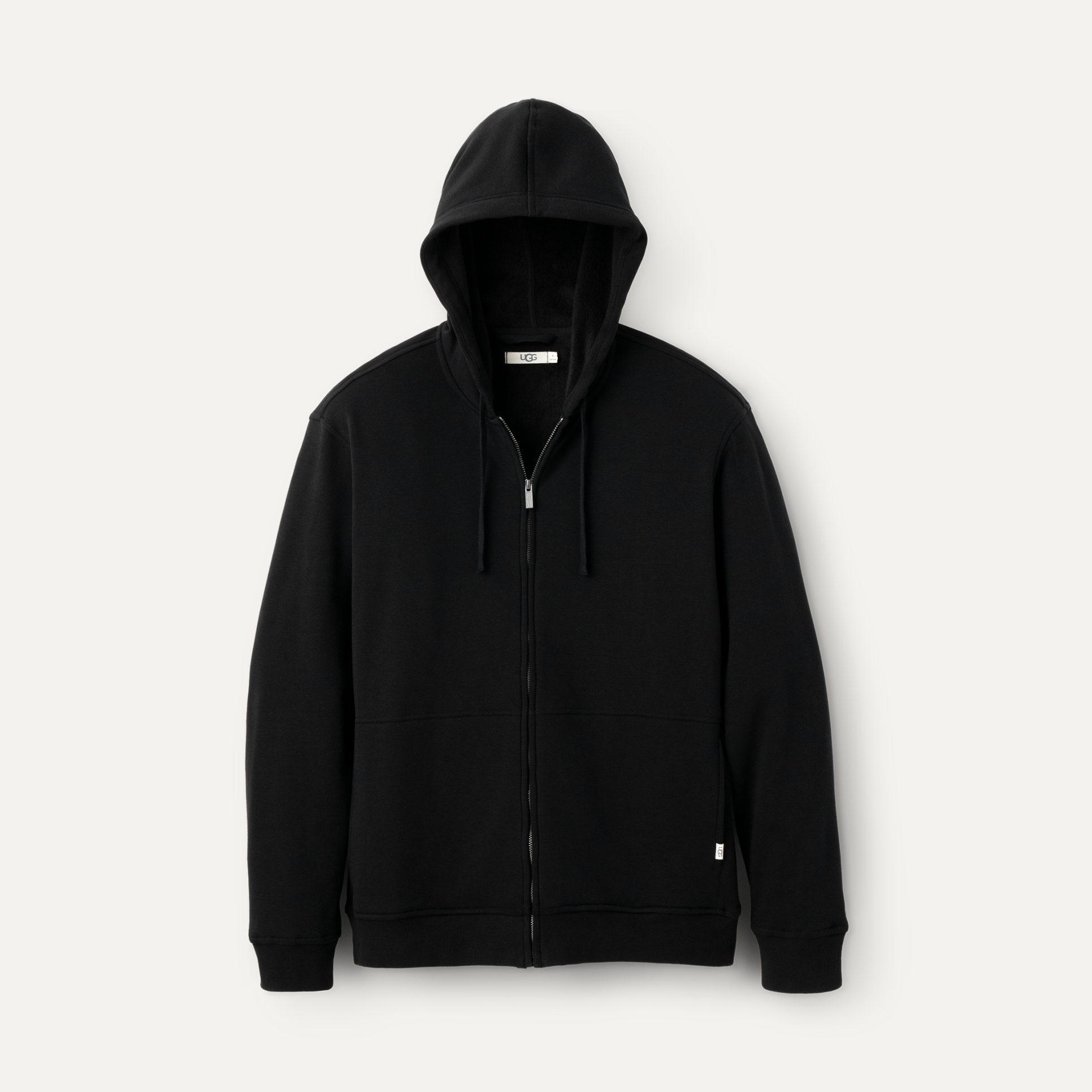 A black UGG men's hoodie with a fleece lining, featuring a hood and ribbed hem. Available at Be Charmed