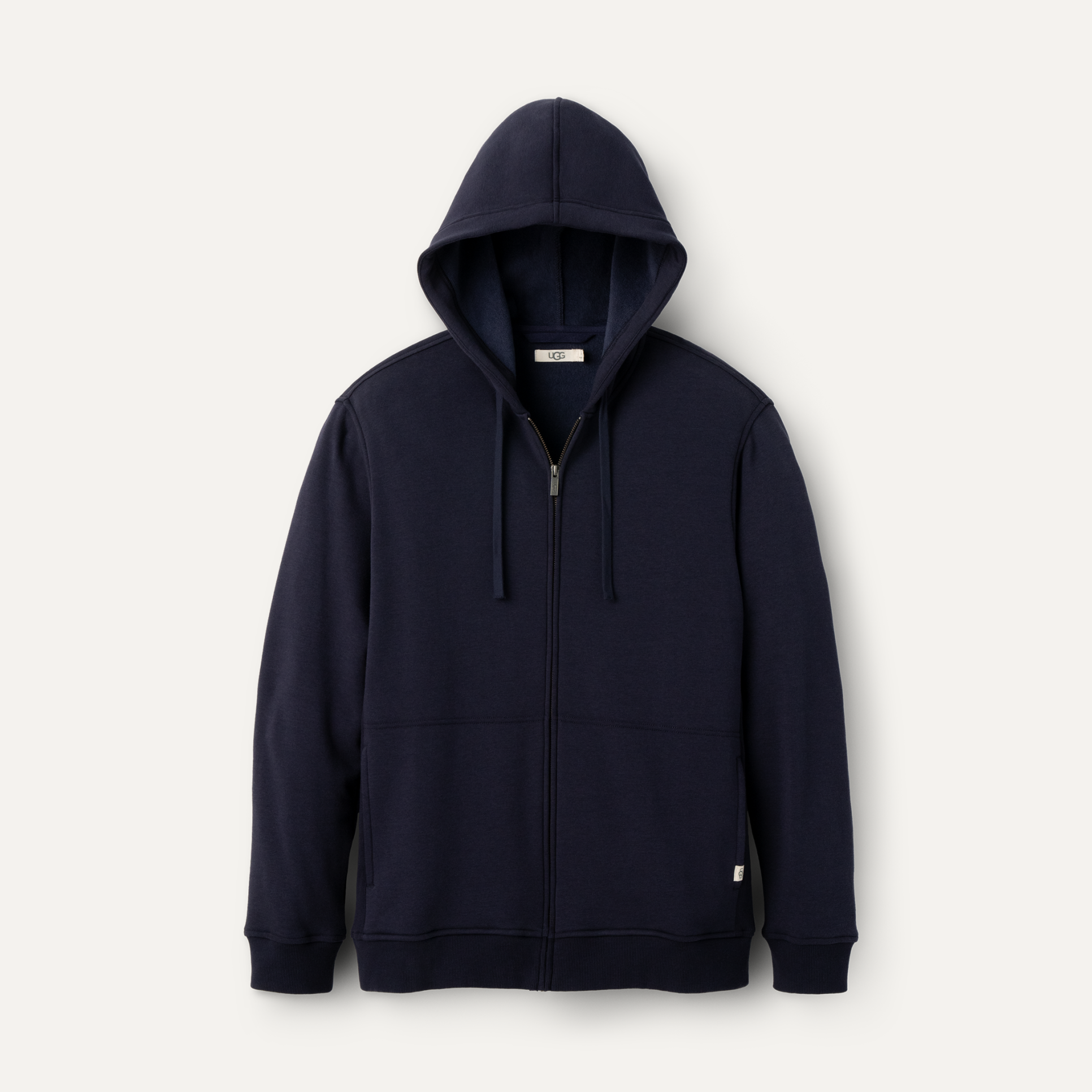 A navy UGG men's hoodie with a fleece lining, featuring a hood and ribbed hem. Available at Be Charmed