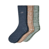 Three pairs of UGG crew socks in heathered navy blue, tan, and sage green, arranged overlapping on a white background. Available at Be Charmed