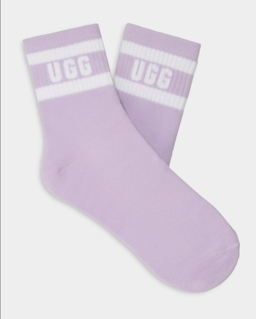 A pair of purple UGG women's socks with white stripes and the UGG logo on the ankle area. Available at Be Charmed