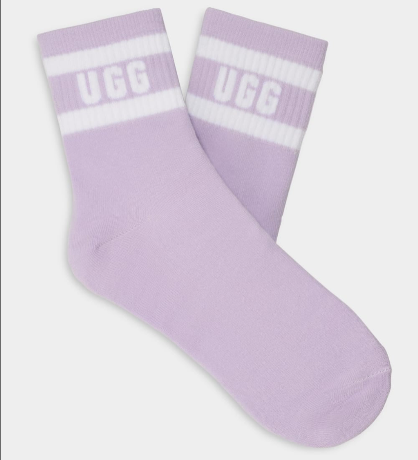 A pair of purple UGG women's socks with white stripes and the UGG logo on the ankle area. Available at Be Charmed