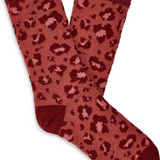 A pair of UGG women's fleece lined socks in red with a brown animal pattern. Available at Be Charmed