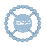 A light blue silicone Bella Tunno baby teether with a circular bead ring and a central wooden spinner disc that reads 'Single and Unemployed' with 'BELLA TUNNO' below it, on a white background. Available at Be Charmed