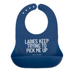 Bella Tunno Blue silicone bib with humorous text on a white background. Available at Be Charmed