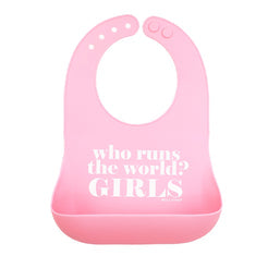 A light pink Bella Tunno silicone baby bib with a darker pink bottom pocket, featuring the white printed text 'who runs the world? GIRLS'. Available at Be Charmed