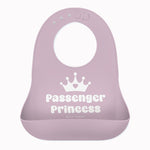 A light purple Bella Tunno silicone baby bib with a white crown graphic and the words 'Passenger Princess' printed on the front, set against a plain white background. Available at Be Charmed
