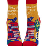 Blue Q, I Got Another Book ankle socks, featuring a humorous graphic design with books and bold typography, available at Be Charmed.