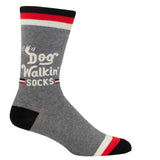 Blue Q Dog Walkin' men's crew socks featuring an illustrated graphic design of dogs and owners, available at Be Charmed
