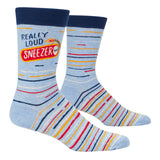 Blue Q Really Loud Sneeze men's crew socks featuring a humorous graphic design with bold typography, available at Be Charmed