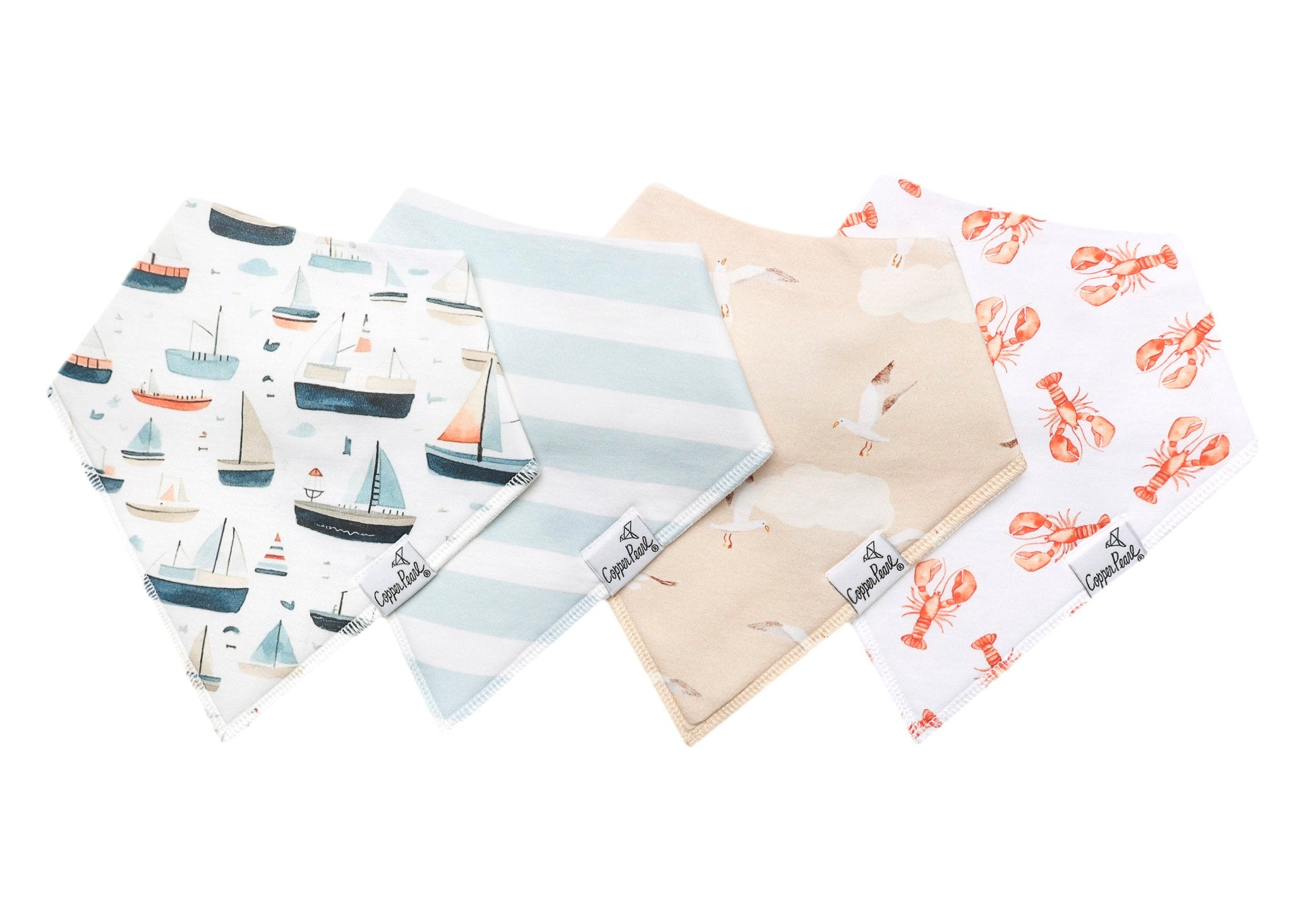 Collection of baby bibs with various patterns on a white background. Available at Be Charmed