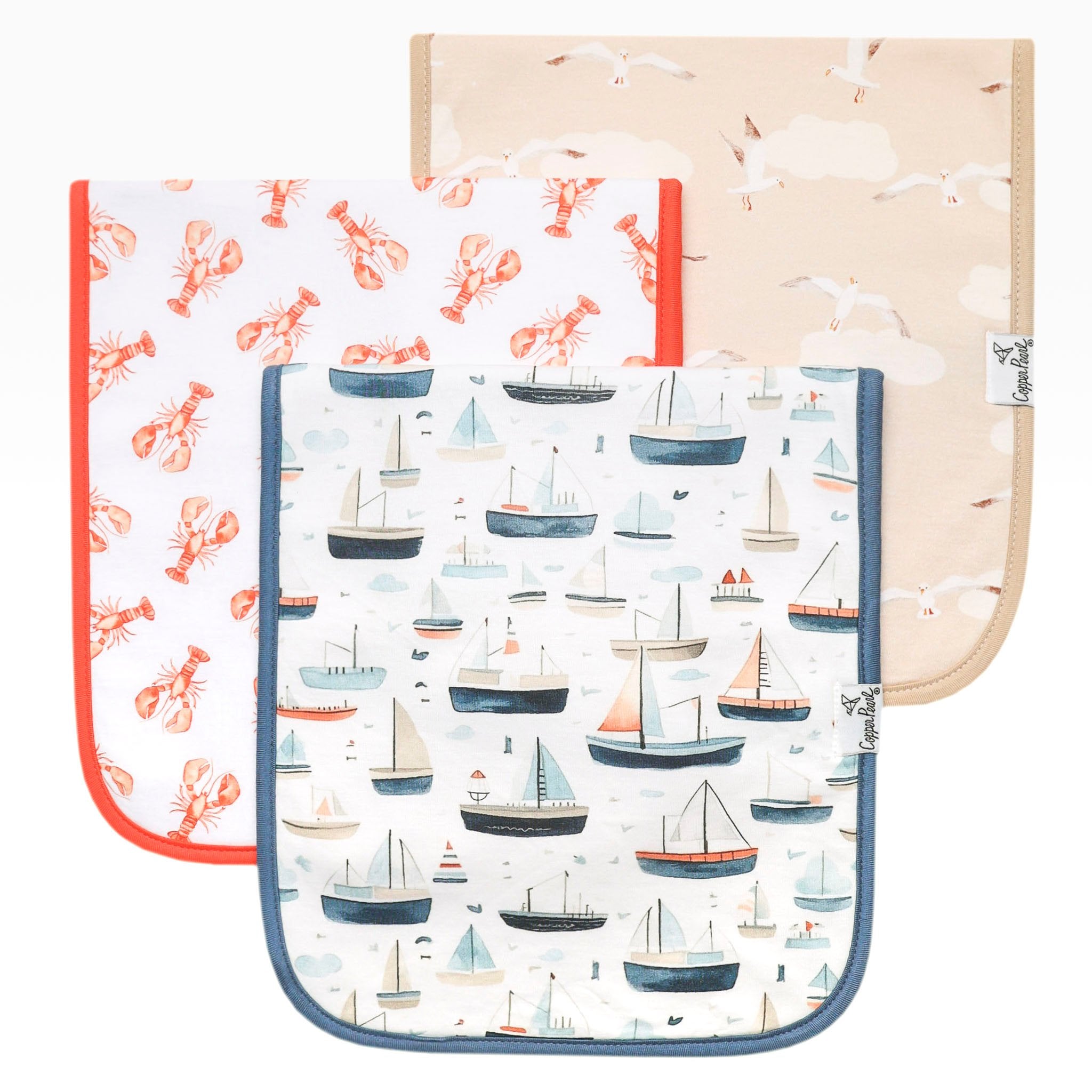 Three baby burp cloths with different patterns on a white background. Available at Be Charmed