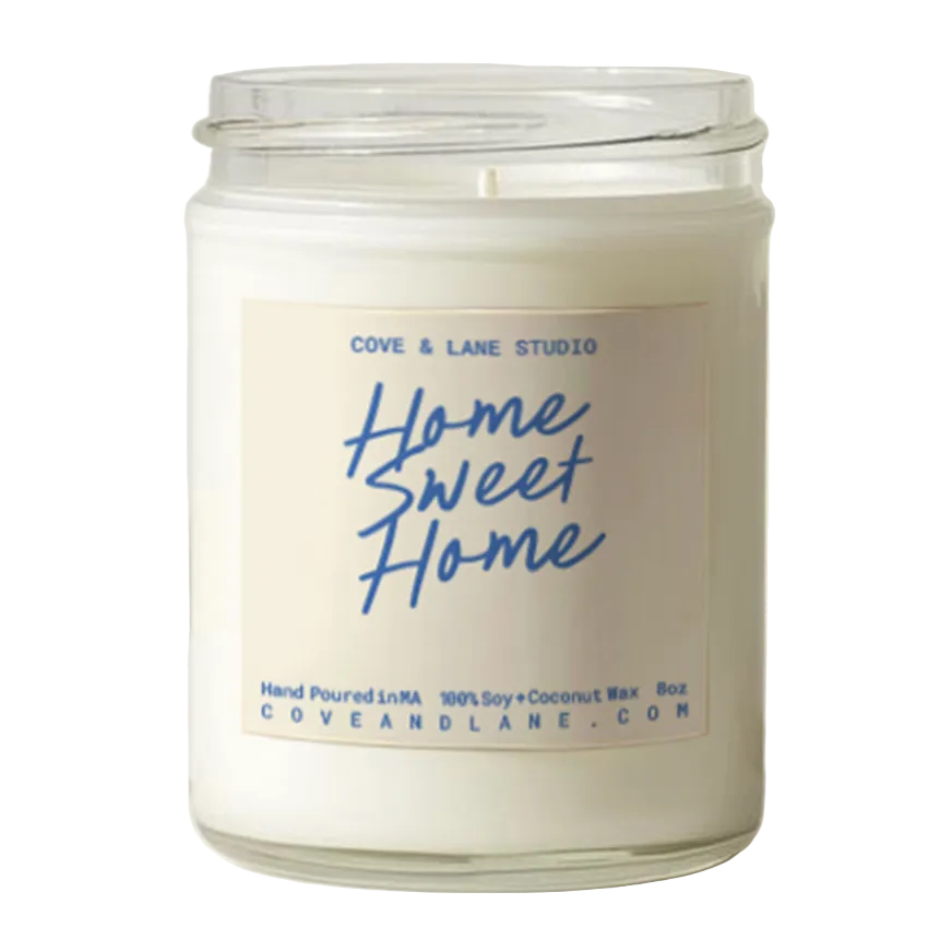 Cove & Lane Candle jar with 'Home Sweet Home' label on a white background. Available at Be Charmed