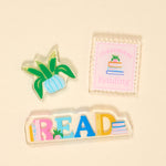 Three book themed magnets on a beige background. Available at Be Charmed