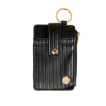 Black textured keychain wallet with gold accents on a beige background. Available at Be Charmed