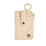 oat cardholder with key ring on a beige background. Available at Be Charme