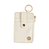 White cardholder with gold accents on a beige background. Available at Be Charmed