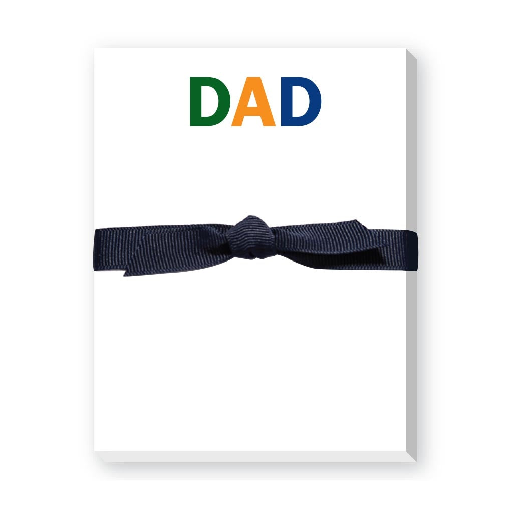 Notepad with 'DAD' in colorful letters and a navy ribbon on a white background. Available at Be Charmed