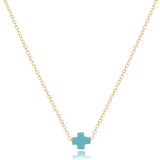 A 16-inch gold-filled chain necklace with a small turquoise signature cross pendant. Available at Be Charmed