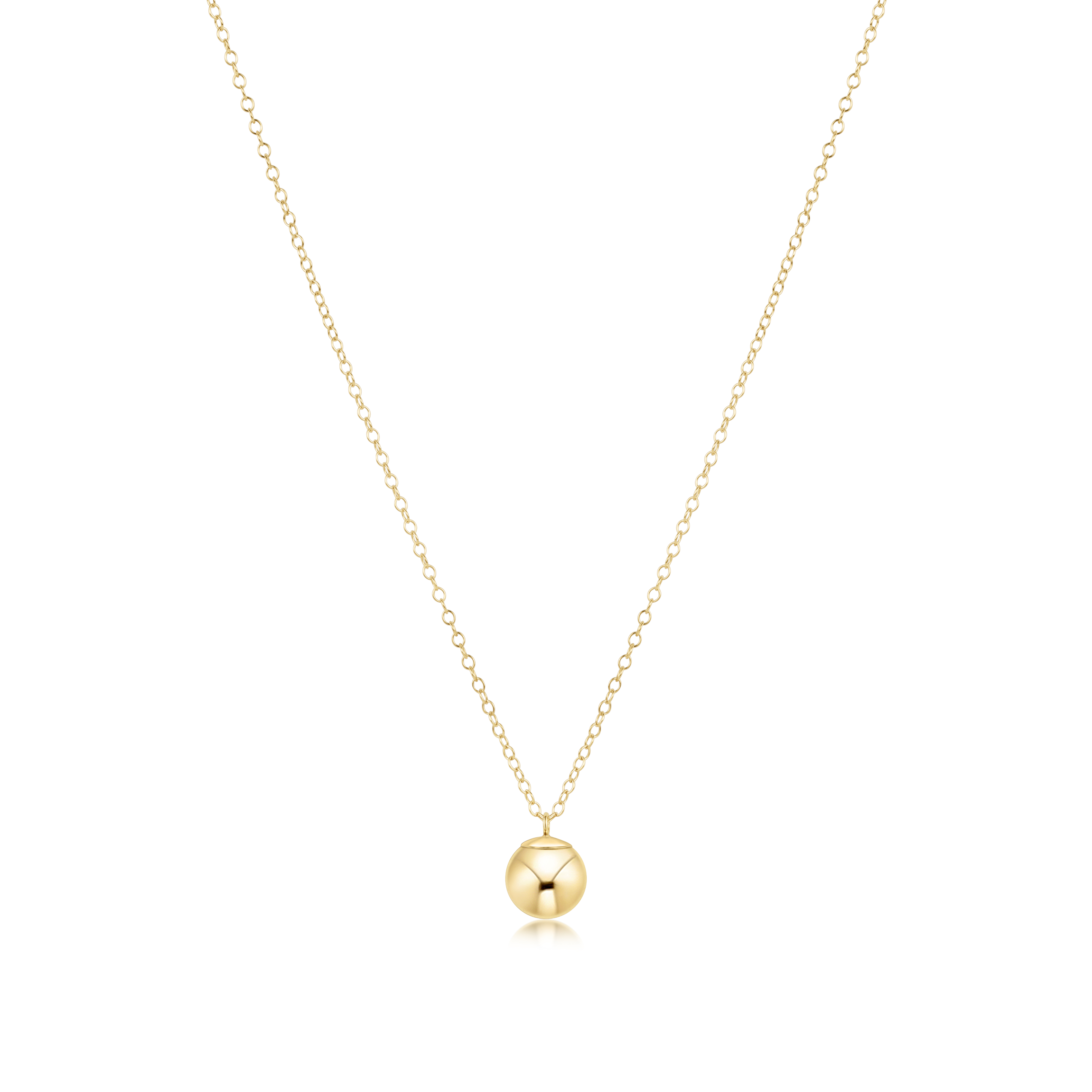 Gold necklace with a round pendant on a white background. Available at Be Charmed