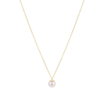 Gold necklace with a single pearl pendant on a white background. Available at Be Charmed