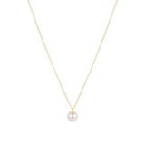 Gold necklace with a single pearl pendant on a white background. Available at Be Charmed