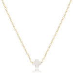 enewton Gold necklace with a off white cross pendant on a white background. Available at Be Charmed