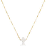 enewton Gold necklace with a off white cross pendant on a white background. Available at Be Charmed