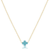 enewton Gold necklace with a turquoise cross pendant on a white background. Available at Be Charmed