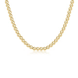 A 17-inch gold-filled choker necklace with 5mm round beads. Available at Be Charmed