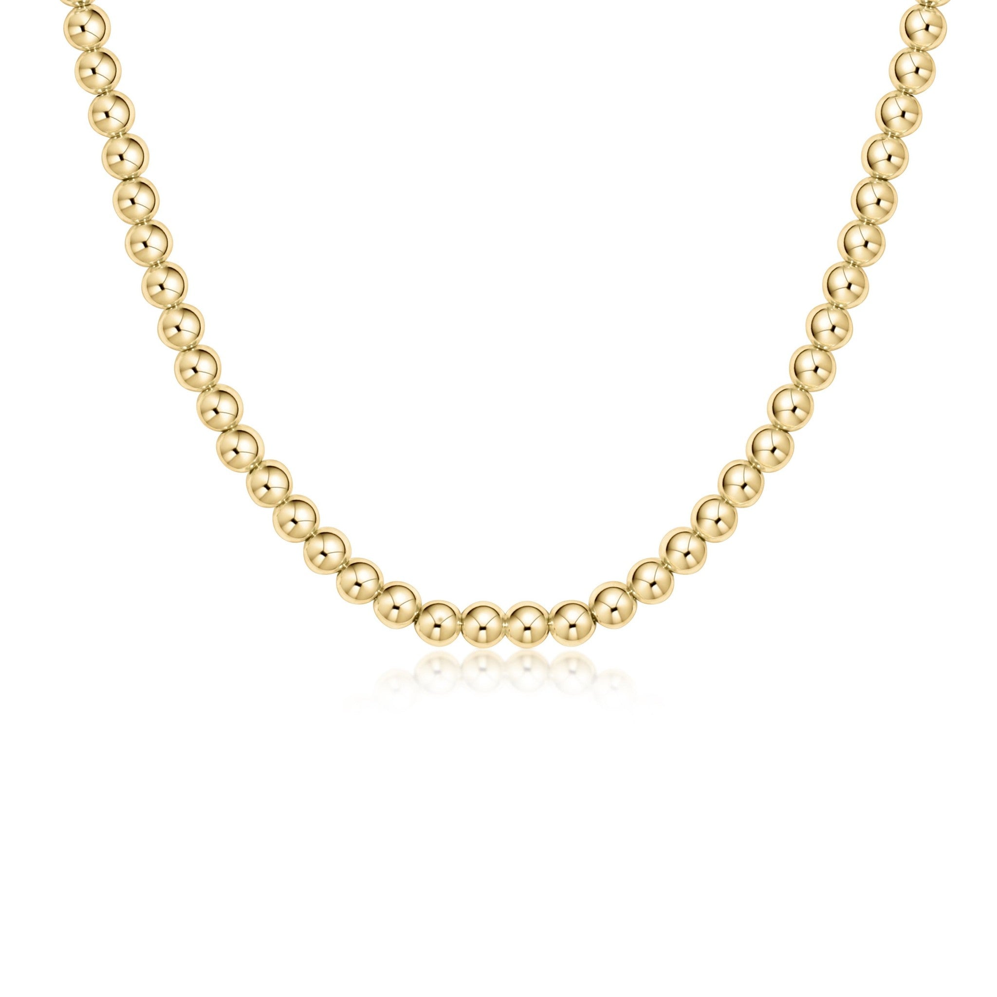 A 17-inch gold-filled choker necklace with 5mm round beads. Available at Be Charmed