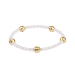Pearl bracelet with gold beads on a white background. Available at Be Charmed