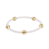 Pearl bracelet with gold beads on a white background. Available at Be Charmed