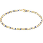 A bracelet with bright blue and gold-colored 2mm seed beads, featuring gold-filled beads. Available at Be Charmed
