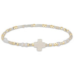 enewton Hope Unwritten Signature Cross Bracelet – Call Me On My Shellphone with cross charm, shellphone bead, and 14k gold-filled beads. Stackable and water-friendly. Available at Be Charmed.