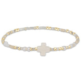 enewton Hope Unwritten Signature Cross Bracelet – Call Me On My Shellphone with cross charm, shellphone bead, and 14k gold-filled beads. Stackable and water-friendly. Available at Be Charmed.