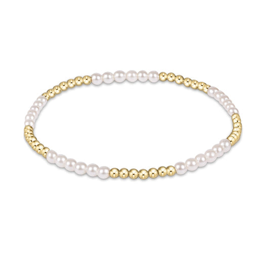 A bracelet with gold-filled beads and pearl accents, featuring a classic blissful pattern. Available at Be Charmed