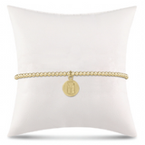 enewton Classic Gold 2.5mm Bead Bracelet featuring stretch design with “Be You” small gold disc charm. Minimalist, elegant style. Available at Be Charmed.