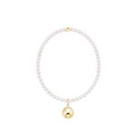 Pearl bracelet with a gold charm on a white background. Available at Be Charmed