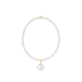 Pearl bracelet with pearl charm on a white background. Available at Be Charmed