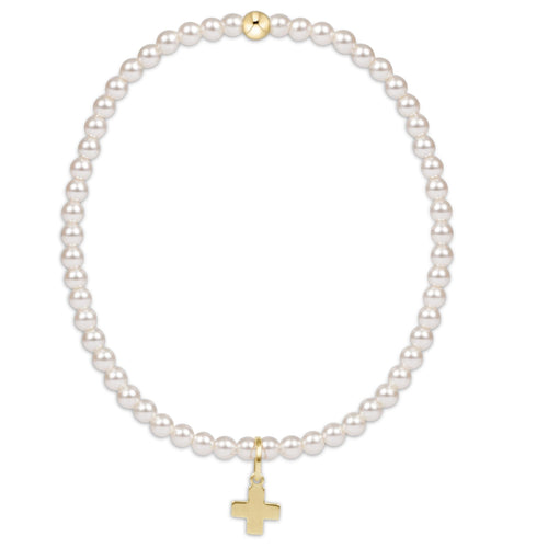 enewton Signature Cross bracelet with 3mm classic pearl beads and subtle cross detail; feminine, spiritual, and stackable. Available at Be Charmed.