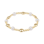 Gold and pearl bracelet on a white background. Available at Be Charmed