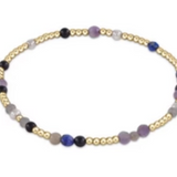 A bracelet with a mix of blue and purple gemstone beads and 14k gold-filled beads, featuring a gold-filled clasp. Available at Be Charmed