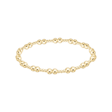 Gold beaded bracelet on a white background. Available at Be Charmed