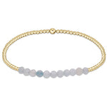 A gold-filled bracelet with aquamarine gemstone beads, featuring a lobster clasp closure. Available at Be Charmed