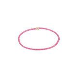 Pink beaded bracelet with a gold clasp on a white background. Available at Be Charmed