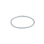 Thin blue beaded bracelet with a gold clasp on a white background. Available at Be Charmed
